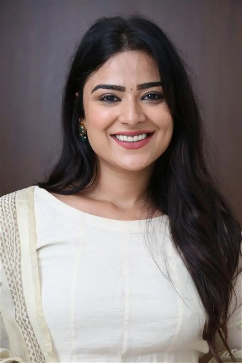 Telugu Actress Priyanka Sharma Smiling Stills in White Dress